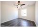 Well-lit bedroom features vinyl floors, a ceiling fan, and a window providing natural light at 4153 W Sunnyside Ave, Phoenix, AZ 85029