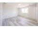 Light-filled bedroom with stylish flooring, a window providing natural light, and neutral color palette at 4153 W Sunnyside Ave, Phoenix, AZ 85029