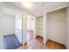 Hallway with a view of a bedroom and an open closet with storage shelves at 4153 W Sunnyside Ave, Phoenix, AZ 85029
