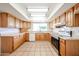 Well-lit kitchen features ample cabinetry, tile floor, stainless steel oven, and bright countertops at 4153 W Sunnyside Ave, Phoenix, AZ 85029