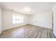 Spacious living room boasts neutral walls, a window for natural light, and wood-look floors at 4153 W Sunnyside Ave, Phoenix, AZ 85029