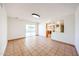 Expansive living room with ceramic tile flooring, open access to the kitchen, and sliding glass doors at 4153 W Sunnyside Ave, Phoenix, AZ 85029