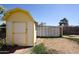 Side view of backyard shed, showing yellow trim and access door at 4153 W Sunnyside Ave, Phoenix, AZ 85029