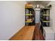 Interior view of shed, showcasing wooden floors, desk, storage, and built-in shelving at 4153 W Sunnyside Ave, Phoenix, AZ 85029