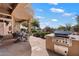 Inviting backyard patio features a built-in barbecue, outdoor dining area and fire pit at 41910 N Long Cove Way, Anthem, AZ 85086