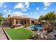 Aerial view of backyard featuring pool, patio, outdoor kitchen, manicured landscaping and pavers at 41910 N Long Cove Way, Anthem, AZ 85086