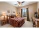 Cozy bedroom featuring neutral walls, ceiling fan, a window and carpeted flooring at 41910 N Long Cove Way, Anthem, AZ 85086