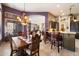 Open dining area with wooden table, chairs, and a decorative chandelier at 41910 N Long Cove Way, Anthem, AZ 85086