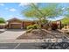 Charming home with a xeriscaped front yard, mature landscaping, and a two-car garage at 41910 N Long Cove Way, Anthem, AZ 85086