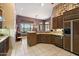 Well-lit kitchen featuring wood cabinets, neutral countertops, and a modern dishwasher at 41910 N Long Cove Way, Anthem, AZ 85086