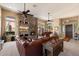 Spacious living area featuring a grand fireplace, comfortable seating, and plenty of natural light at 41910 N Long Cove Way, Anthem, AZ 85086