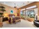 Warm, inviting main bedroom with wood accents, ceiling fan, and ample natural light from large windows at 41910 N Long Cove Way, Anthem, AZ 85086