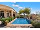 Backyard pool with lush landscaping, a water feature, and a covered patio at 41910 N Long Cove Way, Anthem, AZ 85086