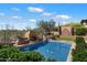 Beautiful pool and yard with a fountain, outdoor bar, and desert views at 41910 N Long Cove Way, Anthem, AZ 85086