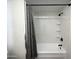 Bathroom features a tub with a decorative curtain rod and modern fixtures at 4750 N Central Ave # M2, Phoenix, AZ 85012