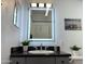 Bathroom vanity highlighted by a modern backlit mirror and neutral color palette at 4750 N Central Ave # M2, Phoenix, AZ 85012