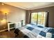 Cozy bedroom featuring a sliding glass door and a white work desk at 4750 N Central Ave # M2, Phoenix, AZ 85012