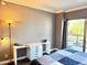 Bedroom with a white desk that features leafy vines and a sliding glass door at 4750 N Central Ave # M2, Phoenix, AZ 85012