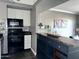 Modern kitchen featuring sleek black countertops, mosaic backsplash, and black appliances at 4750 N Central Ave # M2, Phoenix, AZ 85012