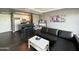 Open-concept living room featuring sleek floors, a kitchen bar, and a comfortable seating area at 4750 N Central Ave # M2, Phoenix, AZ 85012