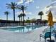 Relaxing community pool with lounge chairs, gazebo, and palm trees under a sunny sky at 4750 N Central Ave # M2, Phoenix, AZ 85012