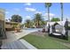 Outdoor oasis with a pool, spa, covered patio, gazebo, and lush landscaping with palm trees at 4904 E Tierra Buena Ln, Scottsdale, AZ 85254