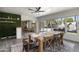 Bright dining area boasts an accent wall, views of the backyard pool, and a large wooden table at 4904 E Tierra Buena Ln, Scottsdale, AZ 85254