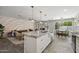 Open-concept kitchen with a large island, modern lighting, and seamless transition to the living area at 4904 E Tierra Buena Ln, Scottsdale, AZ 85254