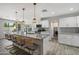 Open kitchen with granite countertops, white cabinets, pendant lighting, and a view of the backyard at 4904 E Tierra Buena Ln, Scottsdale, AZ 85254