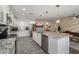 Bright, modern kitchen with white cabinets, a large island, stainless appliances, and wood-look tile at 4904 E Tierra Buena Ln, Scottsdale, AZ 85254