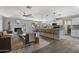 Open-concept living space with a fireplace, ceiling fan, and seamless kitchen access and eat in bar at 4904 E Tierra Buena Ln, Scottsdale, AZ 85254