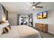 Well lit bedroom features dresser and an exterior door that leads to outdoor seating area at 4904 E Tierra Buena Ln, Scottsdale, AZ 85254