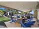 Inviting covered patio with a fire pit, Adirondack chairs, and a view of the pool at 4904 E Tierra Buena Ln, Scottsdale, AZ 85254