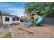 Fun backyard featuring a play structure with slides, swings, and a sandbox for outdoor Gathering enjoyment at 5228 W Aster Dr, Glendale, AZ 85304
