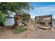 Outdoor play area with playset, swing, sandbox and shaded patio, offering various recreational opportunities at 5228 W Aster Dr, Glendale, AZ 85304