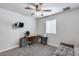 Bedroom with a ceiling fan, desk setup, and a comfortable sofa for versatile living at 5228 W Aster Dr, Glendale, AZ 85304