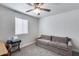 This bedroom offers natural light, neutral carpet, and a comfortable sofa for relaxation at 5228 W Aster Dr, Glendale, AZ 85304