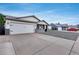 Street view of a charming home featuring a two car garage and a gravel front yard at 5228 W Aster Dr, Glendale, AZ 85304