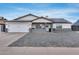 Charming single-story home with a well-maintained yard and a two-car garage on a beautiful sunny day at 5228 W Aster Dr, Glendale, AZ 85304