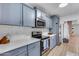 Updated kitchen with white countertops, stainless steel appliances, and shaker cabinets at 5228 W Aster Dr, Glendale, AZ 85304