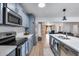 Modern kitchen features stainless steel appliances, white countertops, stylish cabinets and wood flooring at 5228 W Aster Dr, Glendale, AZ 85304