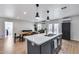 Kitchen island with a sink, stainless steel appliances, and pendant lighting above at 5228 W Aster Dr, Glendale, AZ 85304