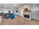 Inviting living space featuring a stone fireplace, plush seating, and an open floor plan flowing into the kitchen at 5228 W Aster Dr, Glendale, AZ 85304