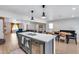 An open floorplan combines the living room, dining area, and kitchen with a central island and modern appliances at 5228 W Aster Dr, Glendale, AZ 85304