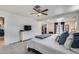 Spacious main bedroom features plush carpeting, a ceiling fan, and a closet at 5228 W Aster Dr, Glendale, AZ 85304