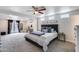 Spacious main bedroom featuring plush carpeting, a ceiling fan, and double doors to the backyard at 5228 W Aster Dr, Glendale, AZ 85304