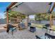 Relaxing patio with a shade cover, a fire pit, and comfortable seating, ideal for outdoor gatherings at 5228 W Aster Dr, Glendale, AZ 85304