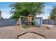 Backyard playground with a wooden playset, swing set, and sandbox, creating a fun area for  at 5228 W Aster Dr, Glendale, AZ 85304