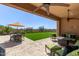 Relaxing backyard featuring lush green lawn, covered patio with dining and seating area perfect for entertaining at 6125 E Hodges St, Cave Creek, AZ 85331