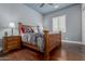 Cozy bedroom featuring a wooden bed frame, hardwood floors, and a window with plantation shutters at 6125 E Hodges St, Cave Creek, AZ 85331